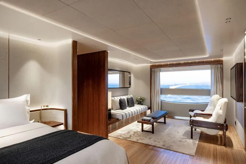 a room with a bed and a television aboard TOSUN Yacht for Sale