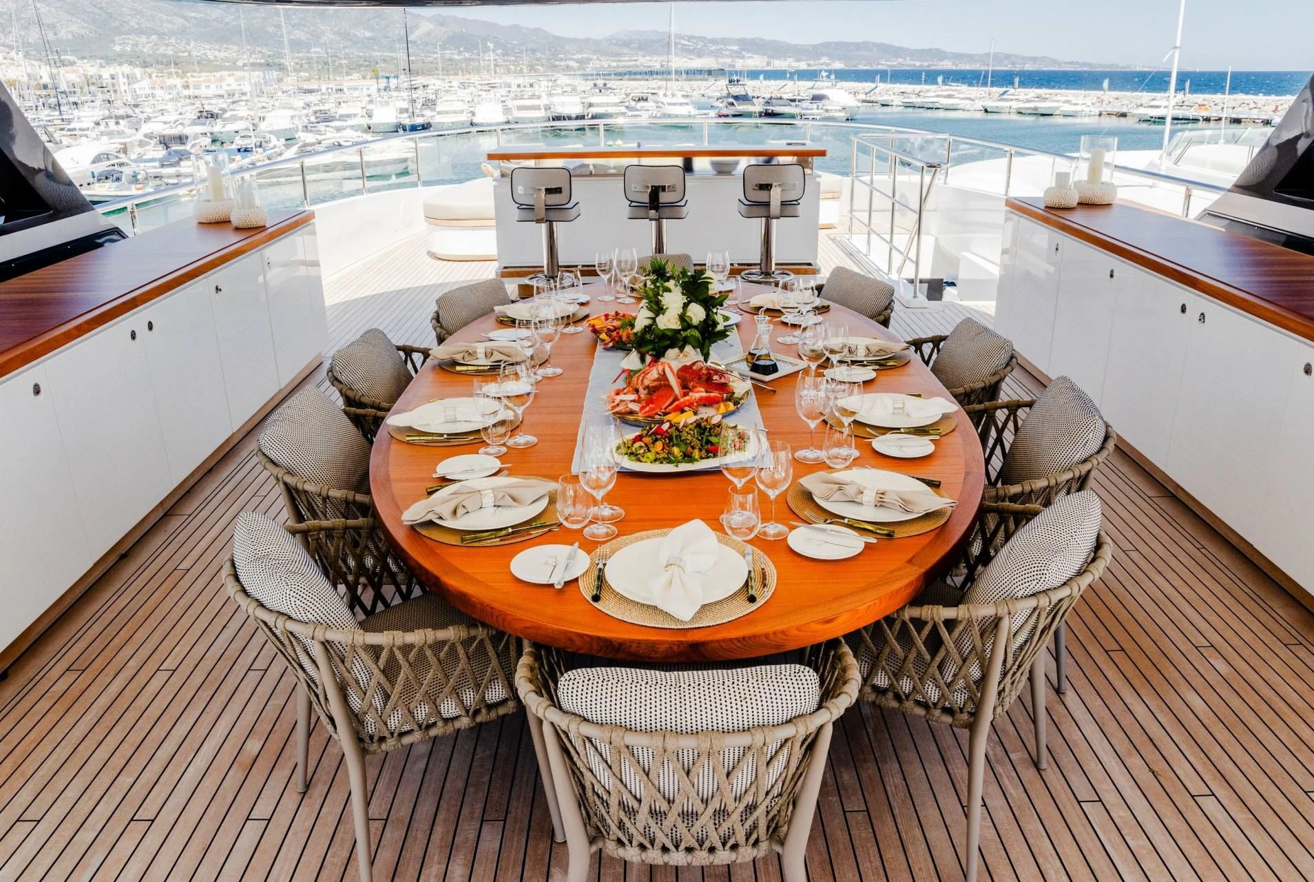 a table set for a meal on a deck aboard TOSUN Yacht for Sale