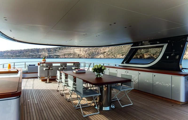 a room with a table and chairs aboard TOSUN Yacht for Sale