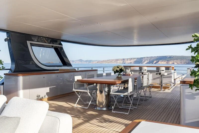 a room with a table and chairs aboard TOSUN Yacht for Sale