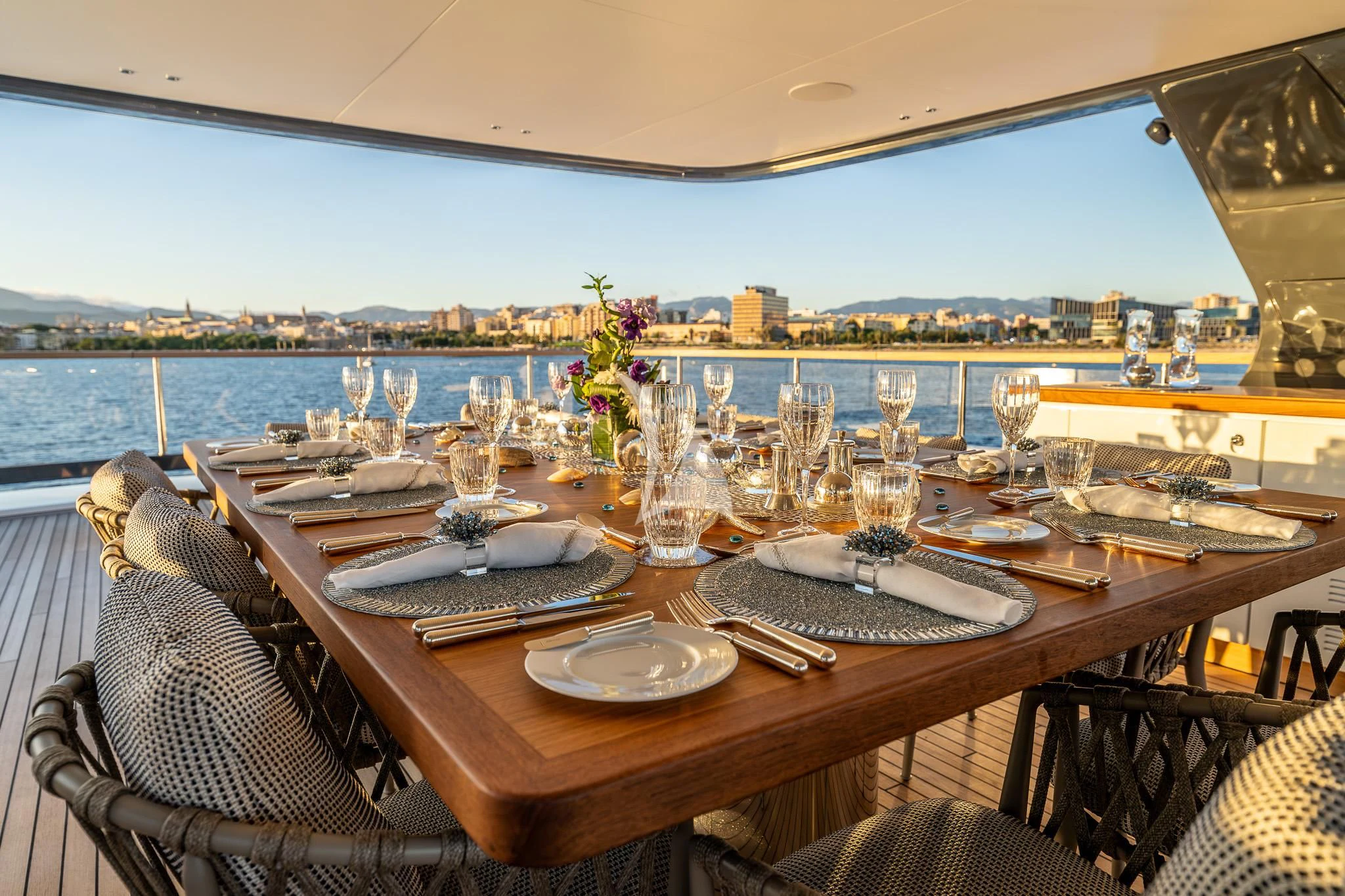 a table with plates and glasses on it aboard TOSUN Yacht for Sale