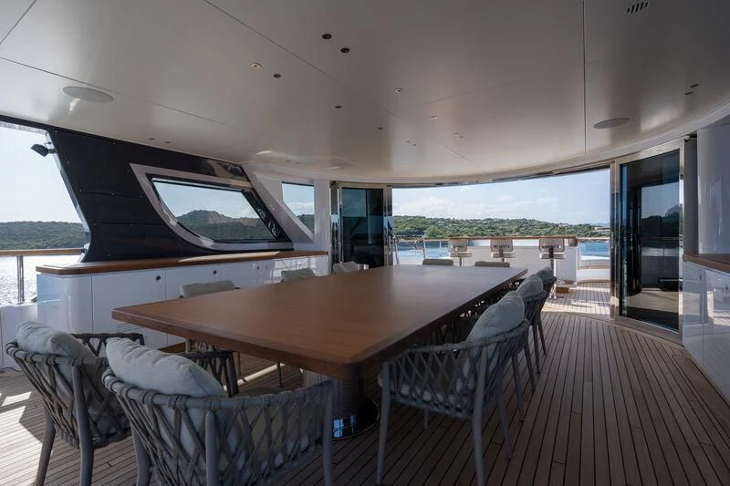 a table with chairs around it aboard TOSUN Yacht for Sale