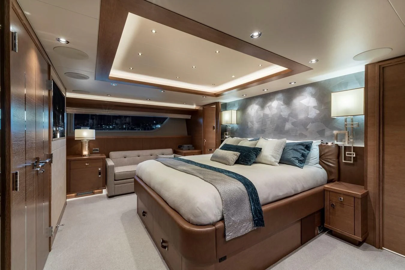 a bedroom with a bed and a lamp aboard WESTPORT 112 #7766 Yacht for Sale