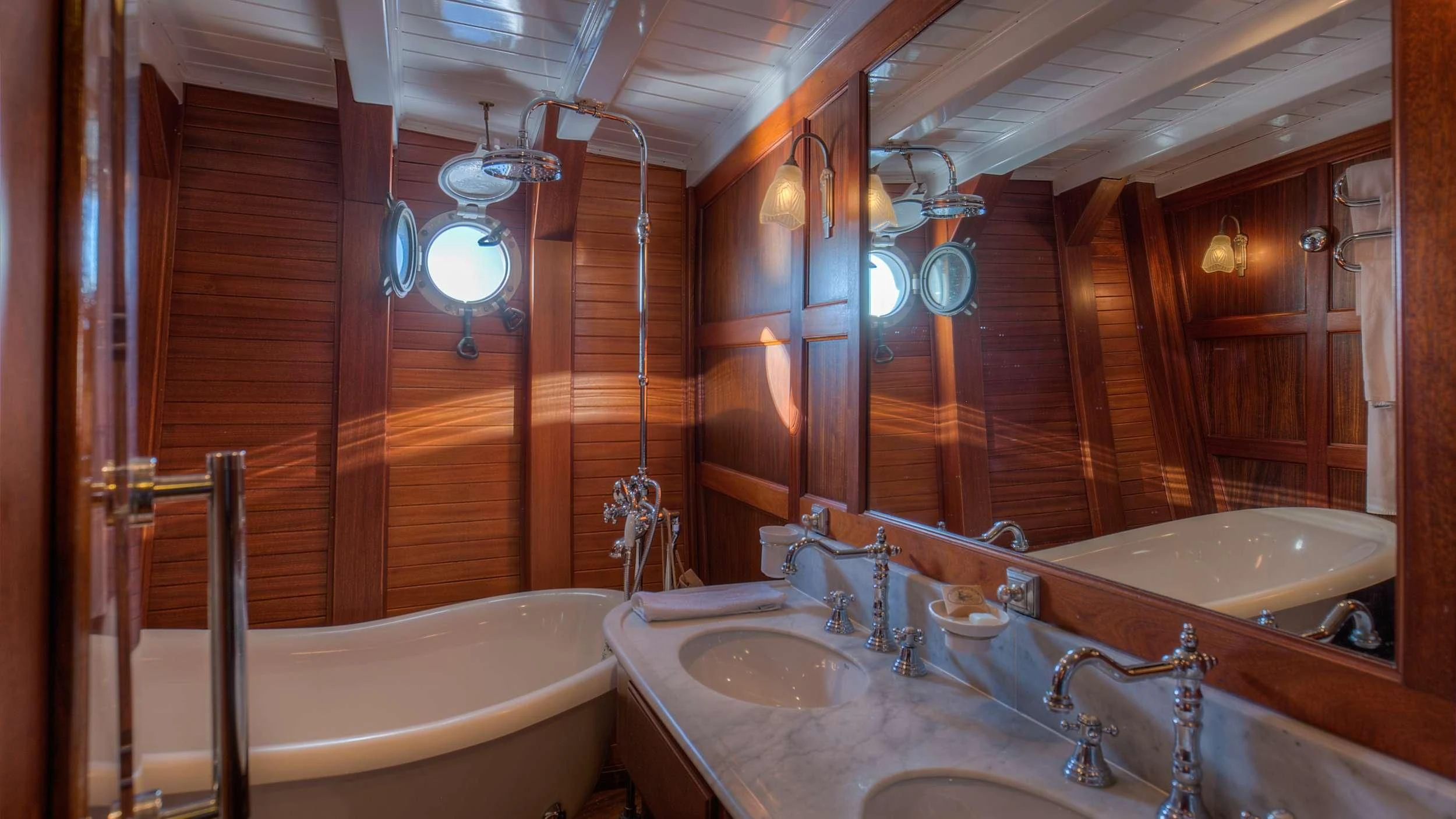 a bathroom with a sink and a bathtub aboard TRINAKRIA Yacht for Charter
