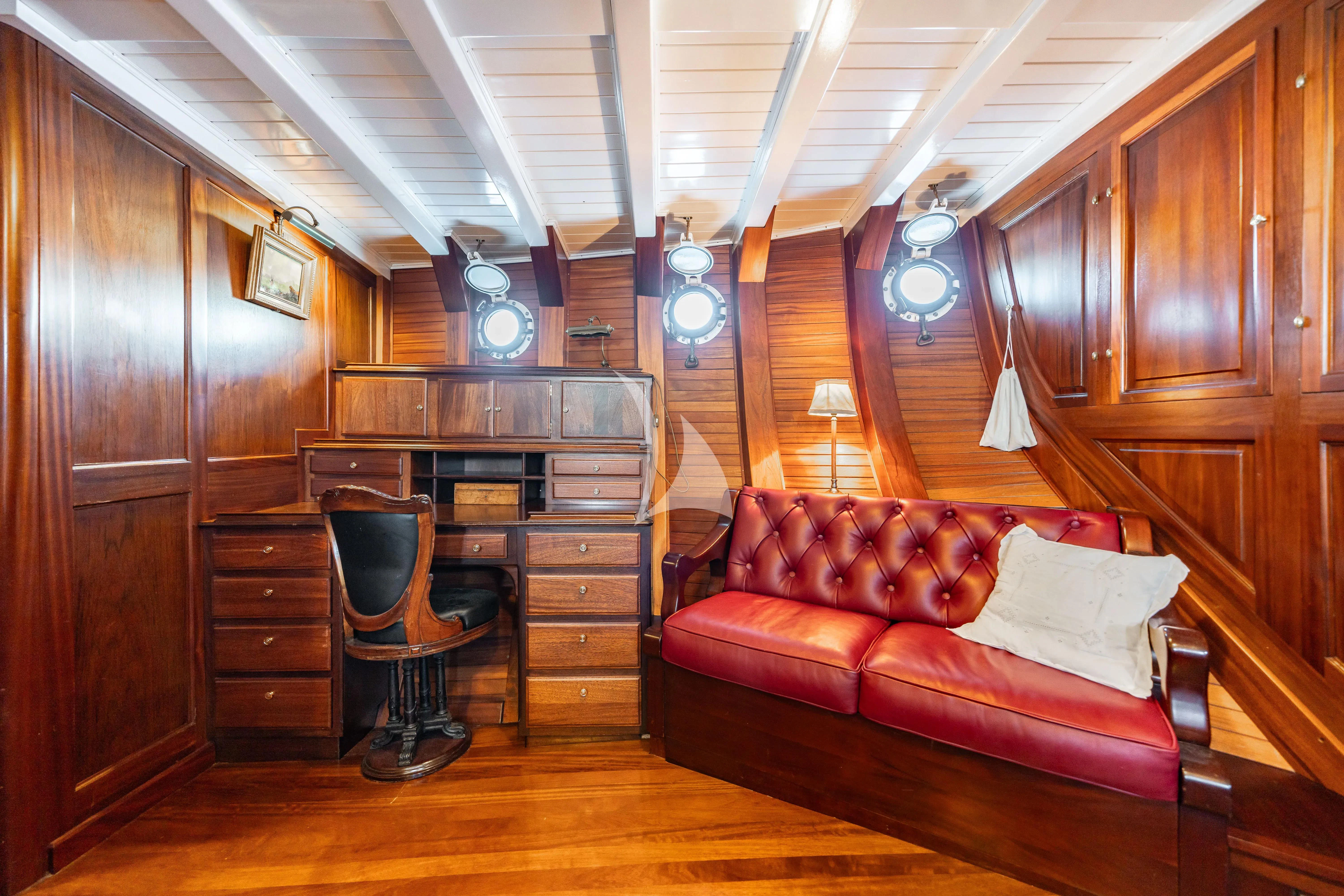 a living room with a couch and a table aboard TRINAKRIA Yacht for Charter