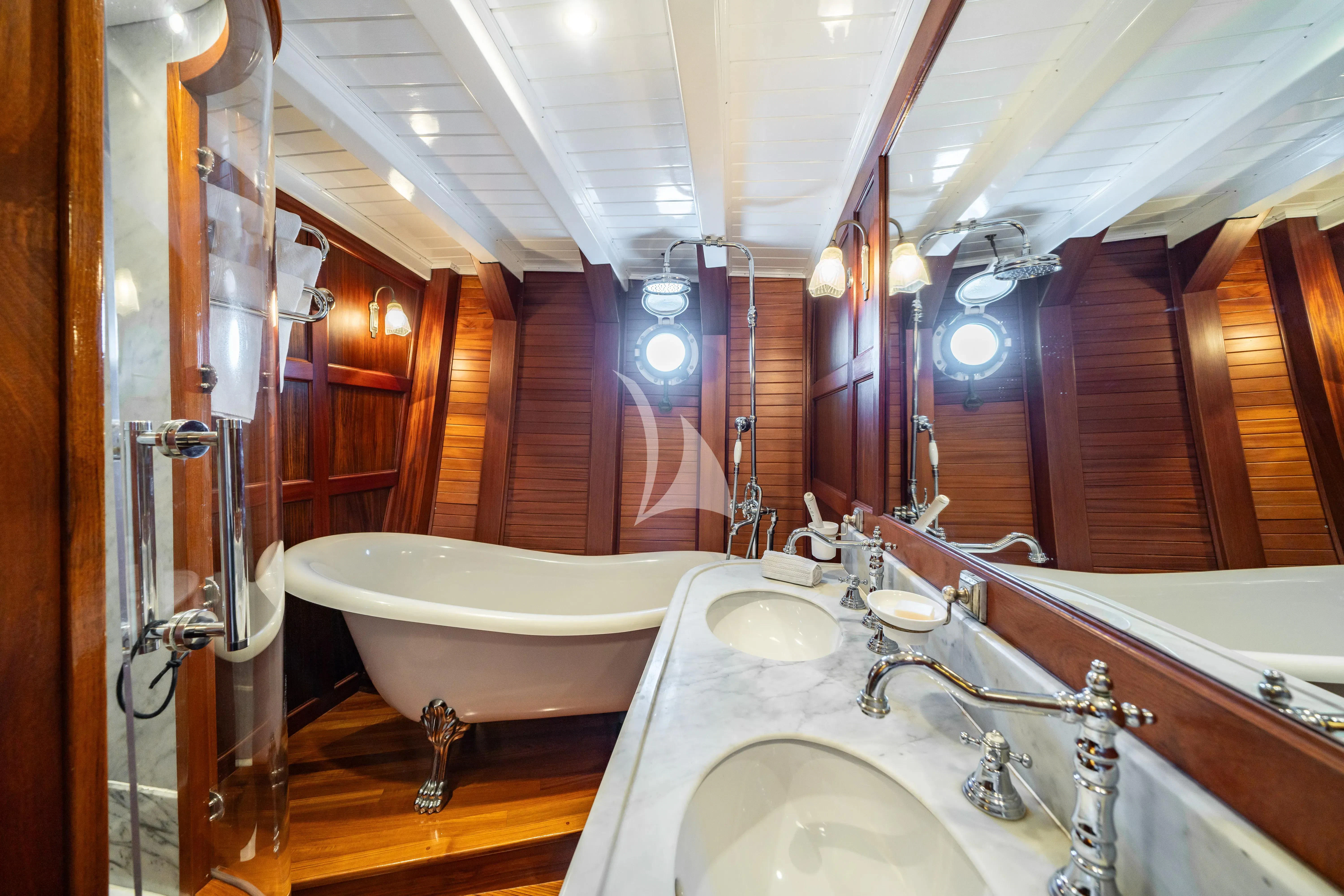 a bathroom with a tub sink and sinks aboard TRINAKRIA Yacht for Charter