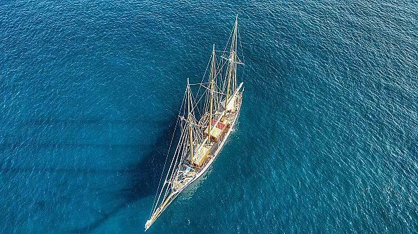 a ship in the ocean aboard TRINAKRIA Yacht for Charter