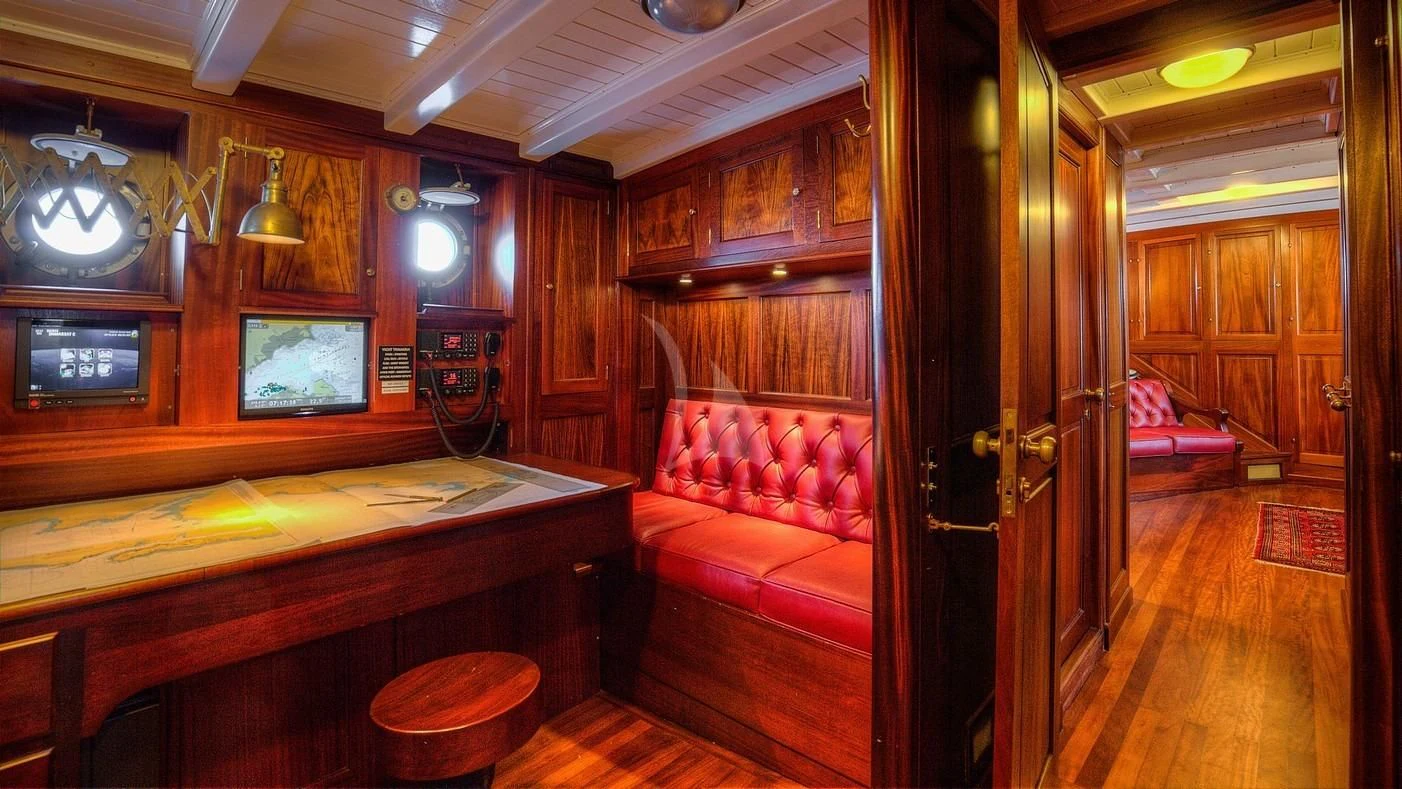 a room with a bed and a tv aboard TRINAKRIA Yacht for Charter