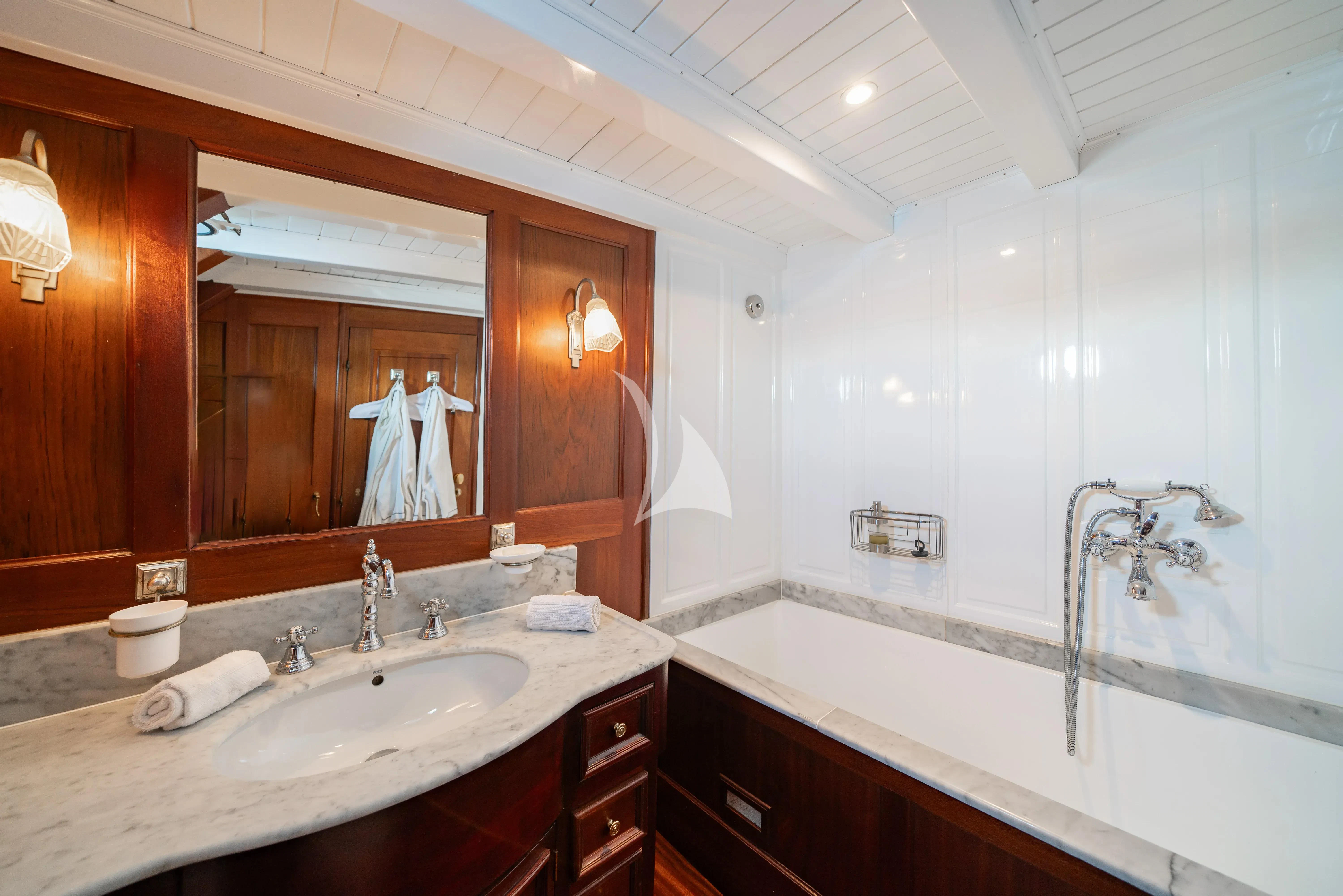 a bathroom with a large mirror aboard TRINAKRIA Yacht for Charter