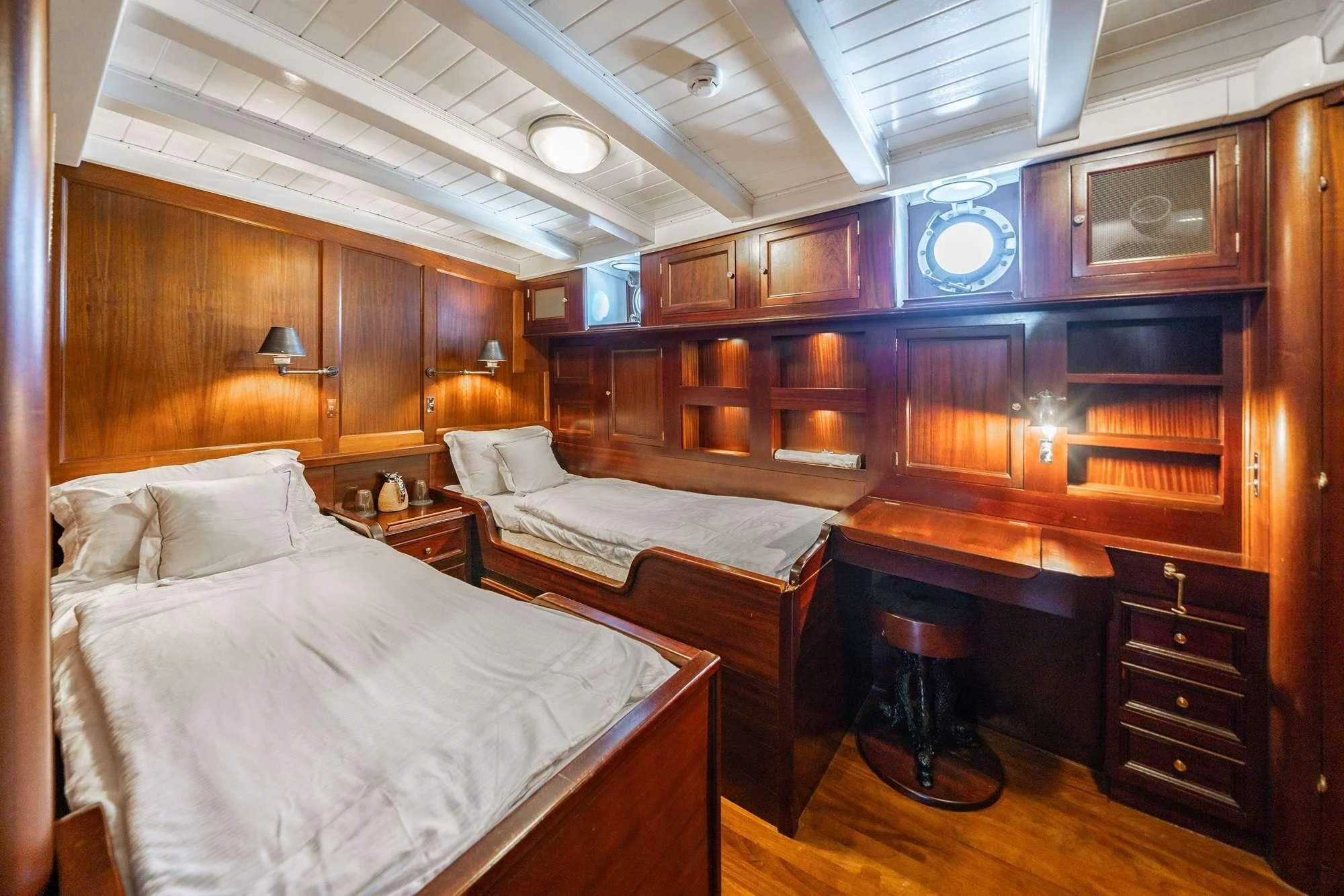 a room with a bed and a fireplace aboard TRINAKRIA Yacht for Charter