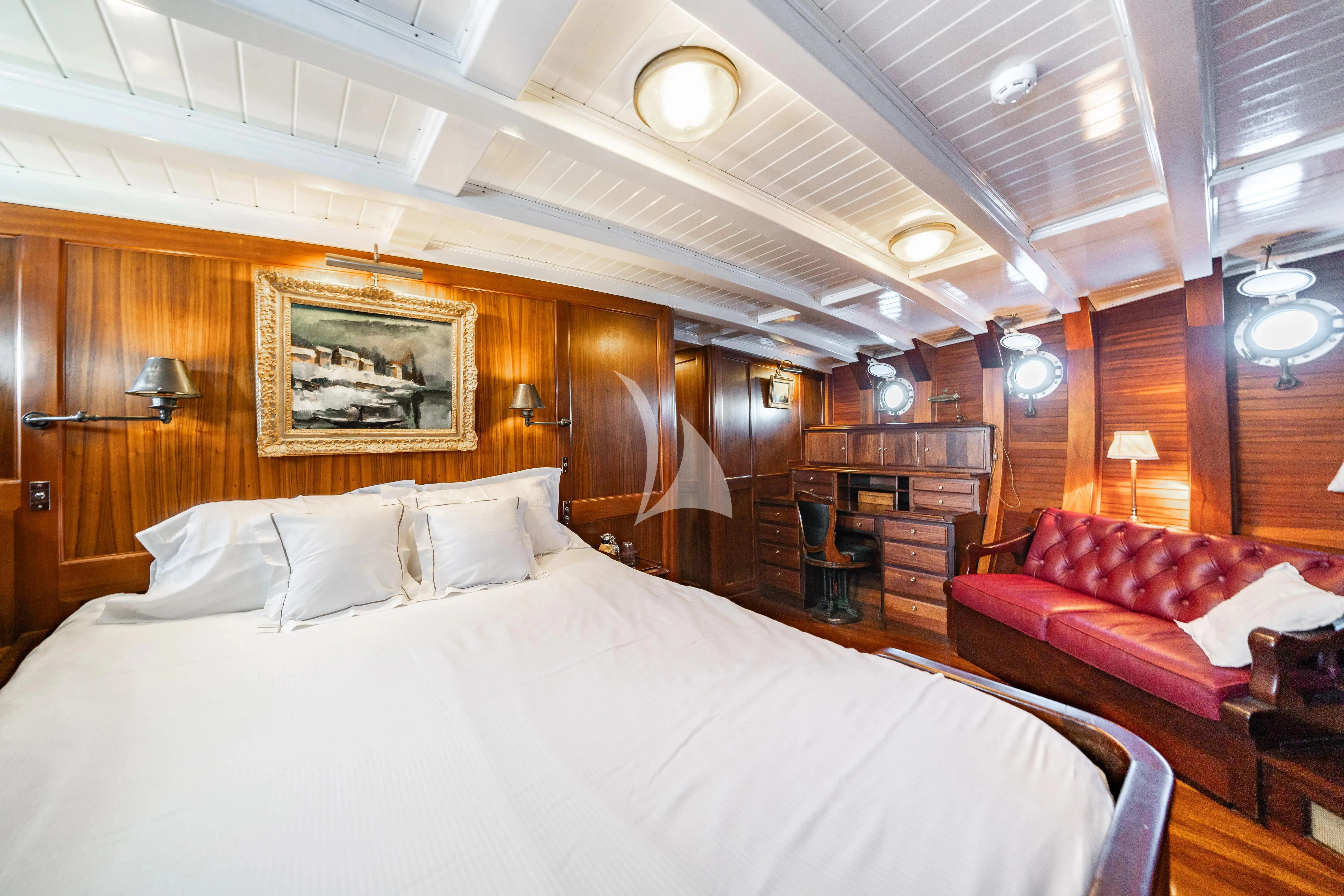 a large bed in a room aboard TRINAKRIA Yacht for Charter