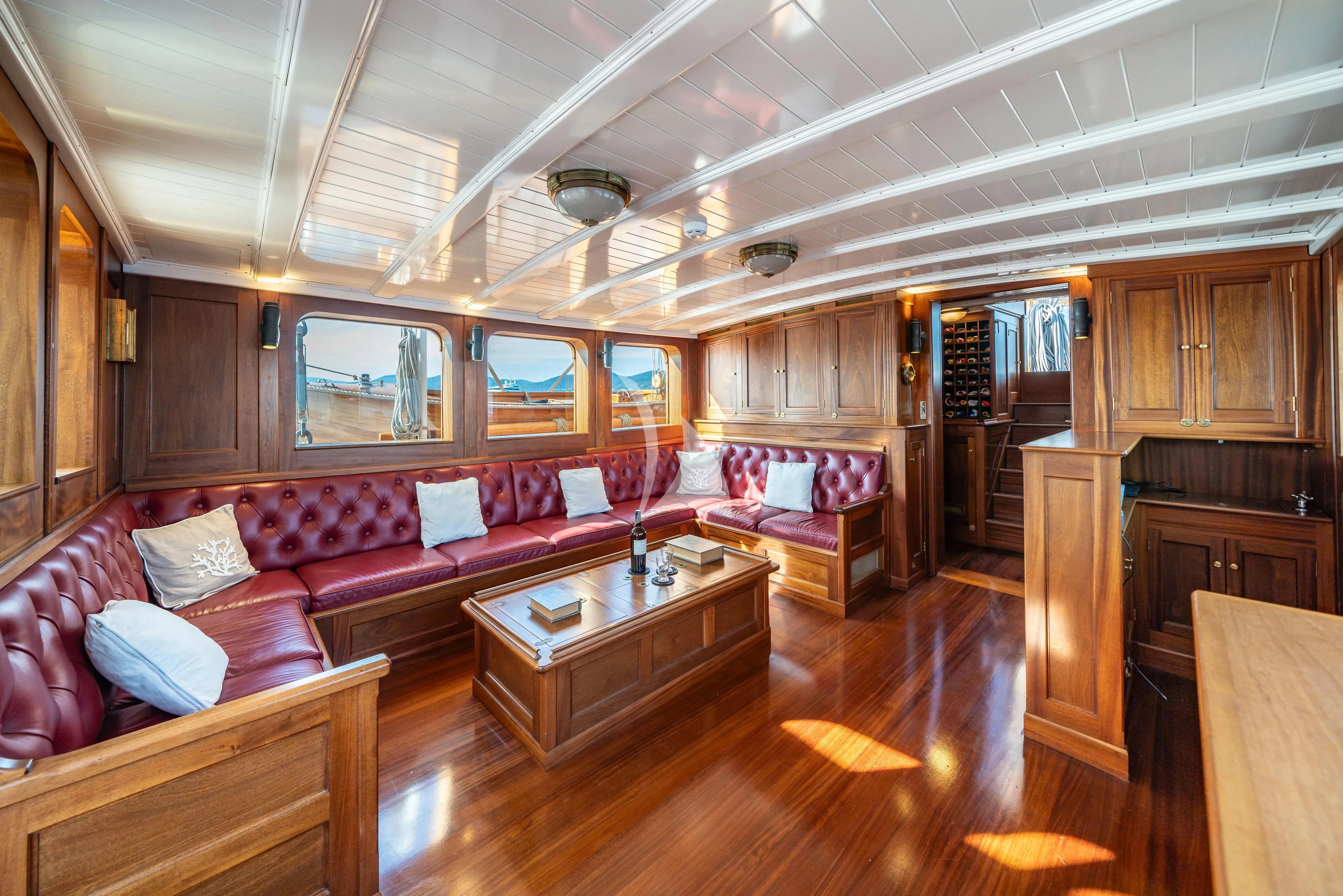 a living room with a couch and a table aboard TRINAKRIA Yacht for Charter