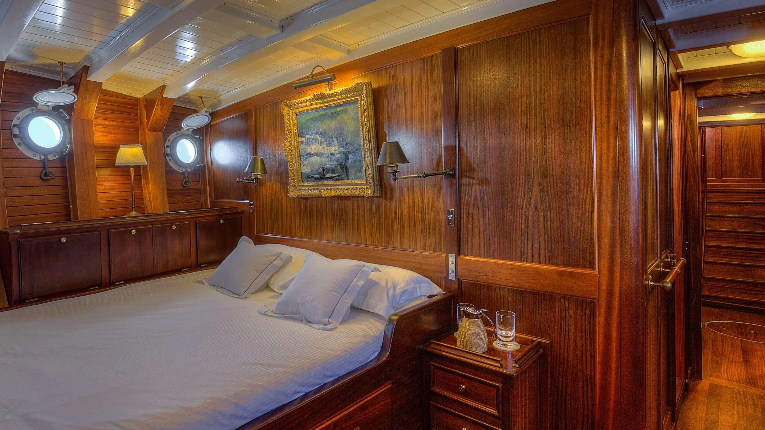 a bed in a wooden room aboard TRINAKRIA Yacht for Charter