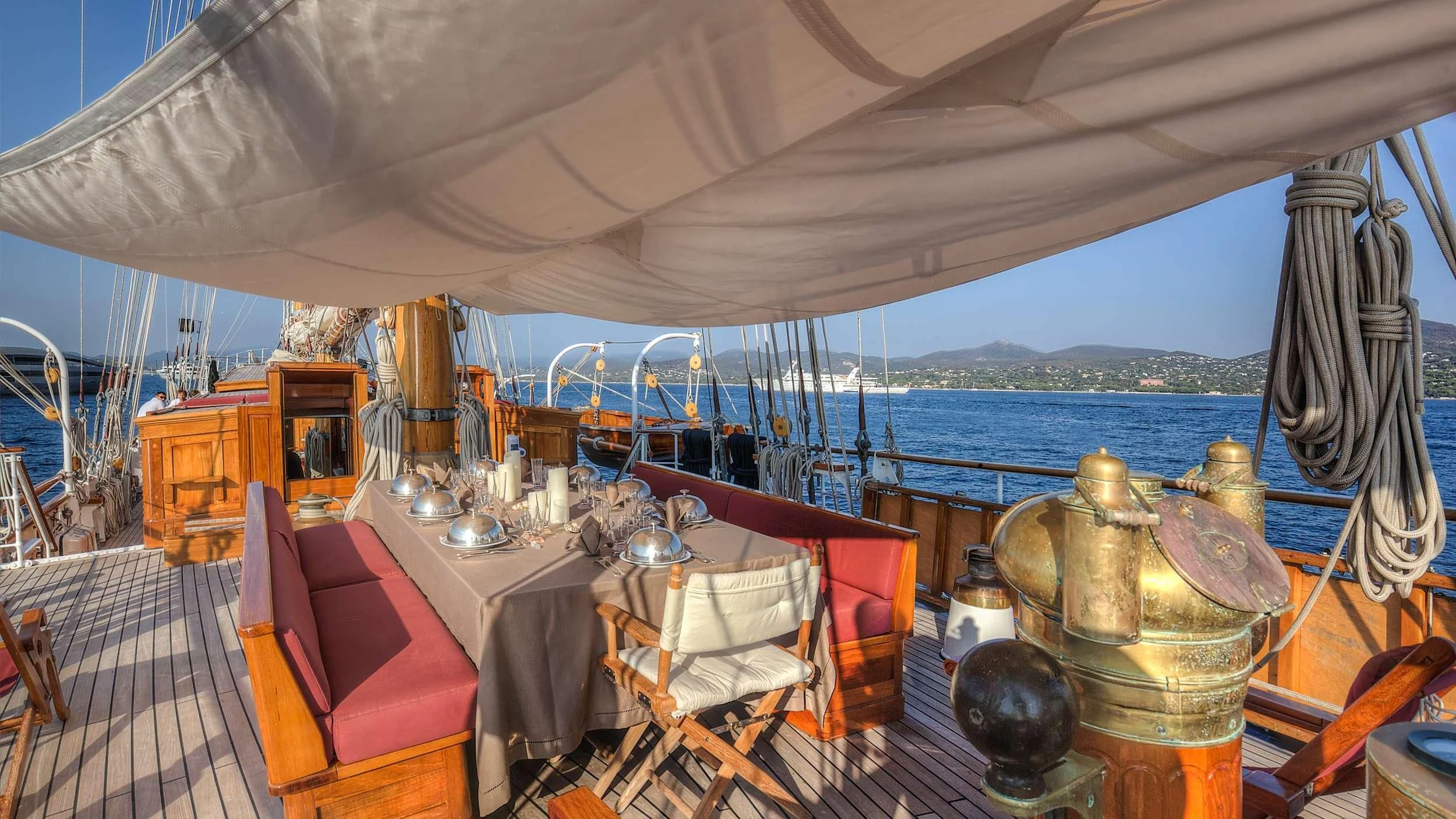 a tent with a table and chairs aboard TRINAKRIA Yacht for Charter