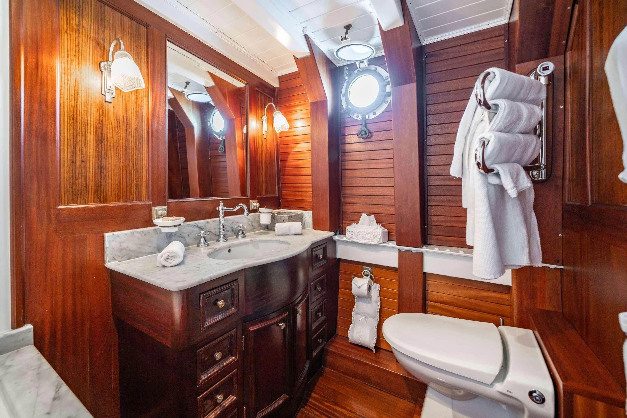 a bathroom with a sink and a toilet aboard TRINAKRIA Yacht for Charter