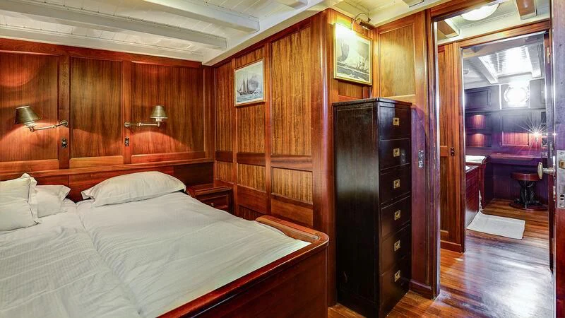 a bedroom with a bed and a closet aboard TRINAKRIA Yacht for Charter