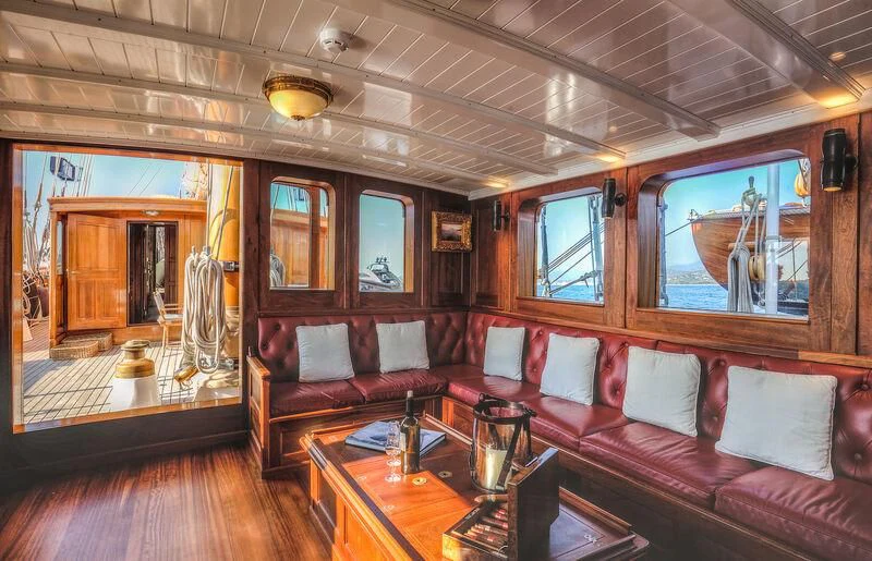 a living room with a wood floor aboard TRINAKRIA Yacht for Charter