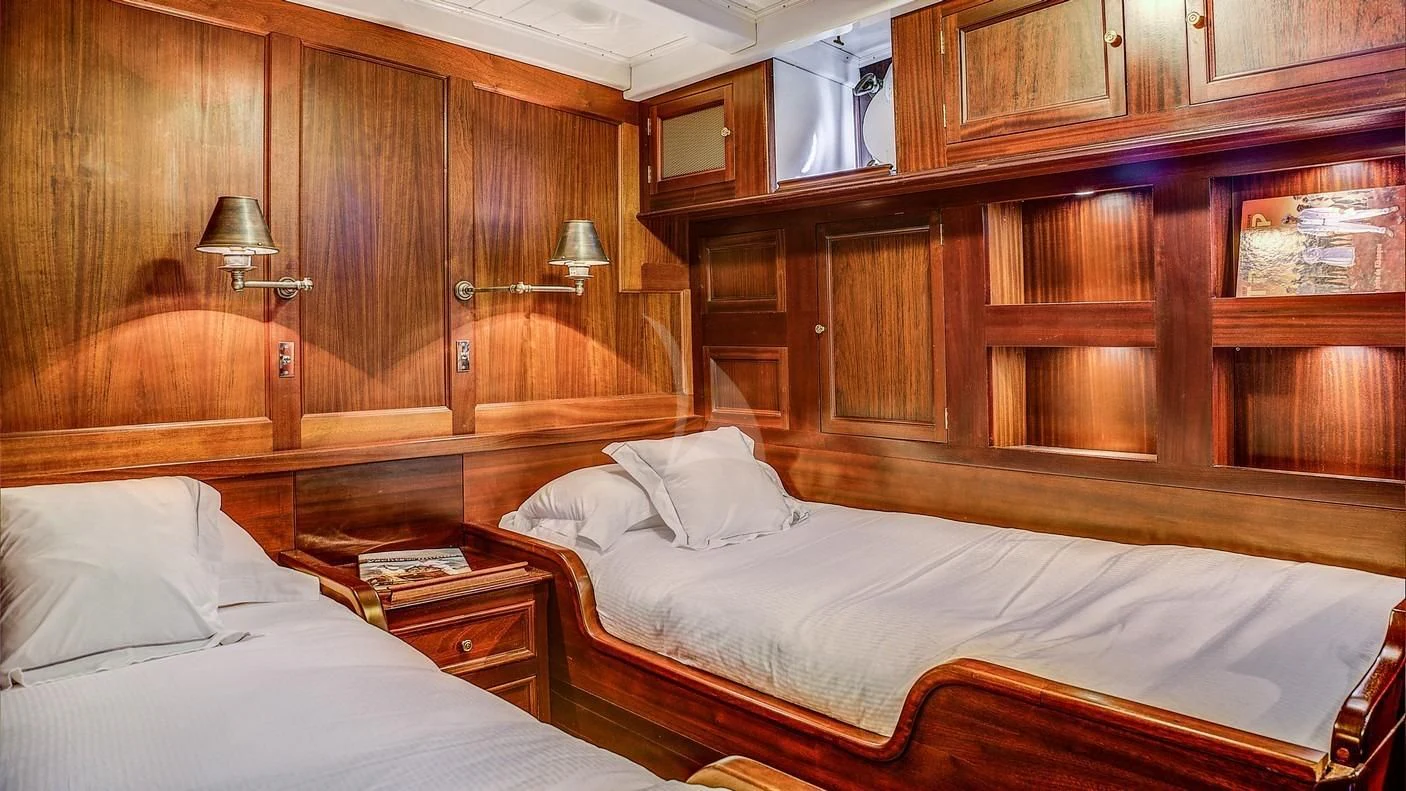 a room with wooden furniture aboard TRINAKRIA Yacht for Charter
