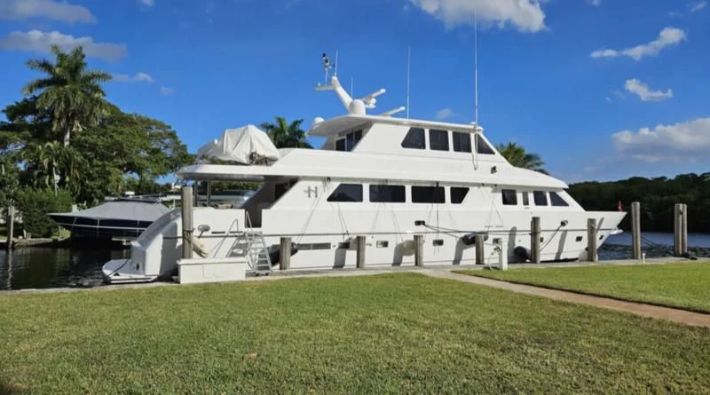 a white yacht docked at a pier aboard LADY D Yacht for Sale