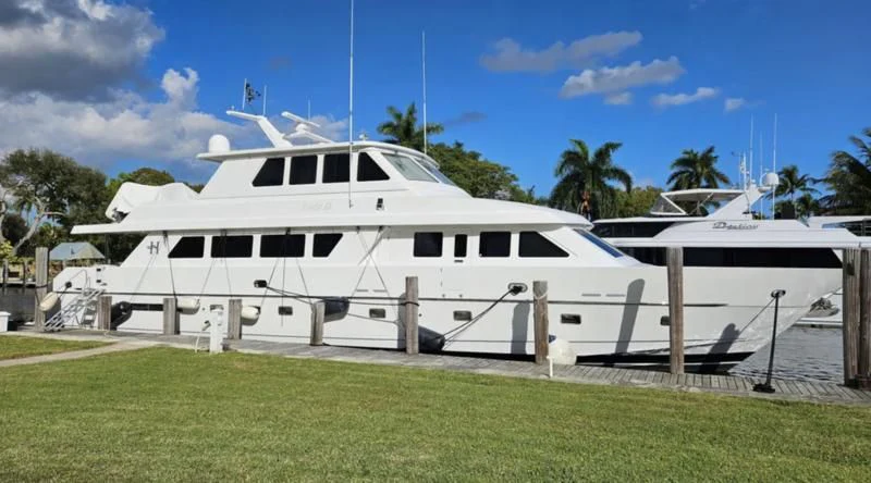 a white boat in a yard aboard LADY D Yacht for Sale