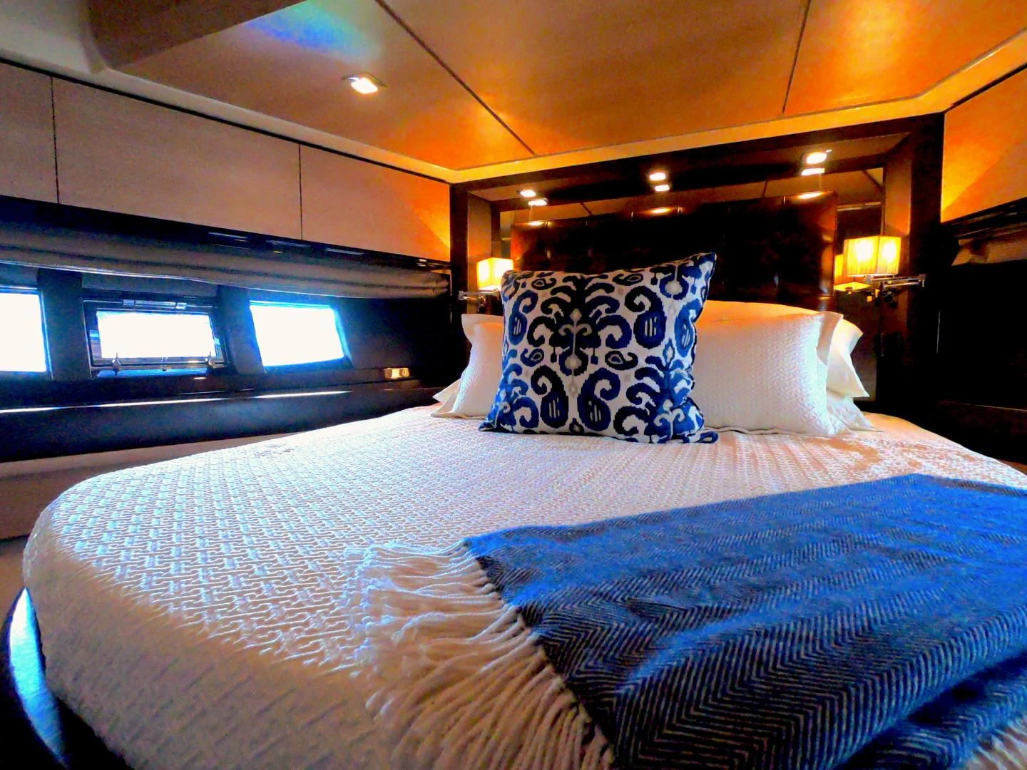 a bed with blue and white sheets aboard BT 2 Yacht for Sale