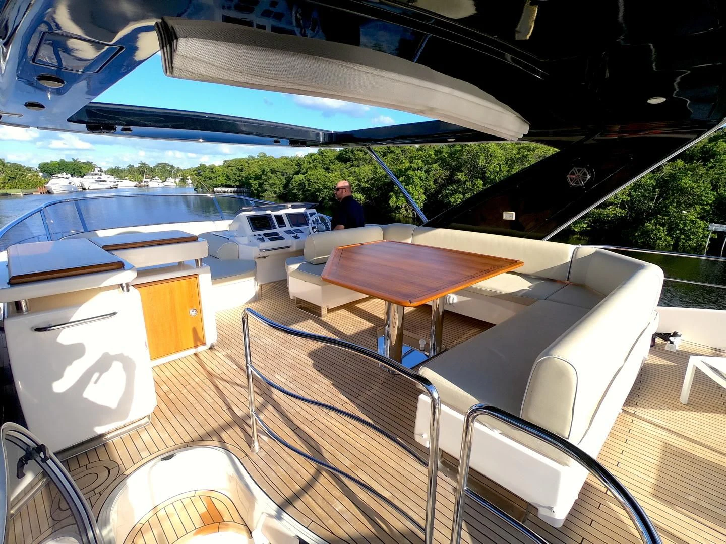 a deck with a table and chairs aboard BT 2 Yacht for Sale