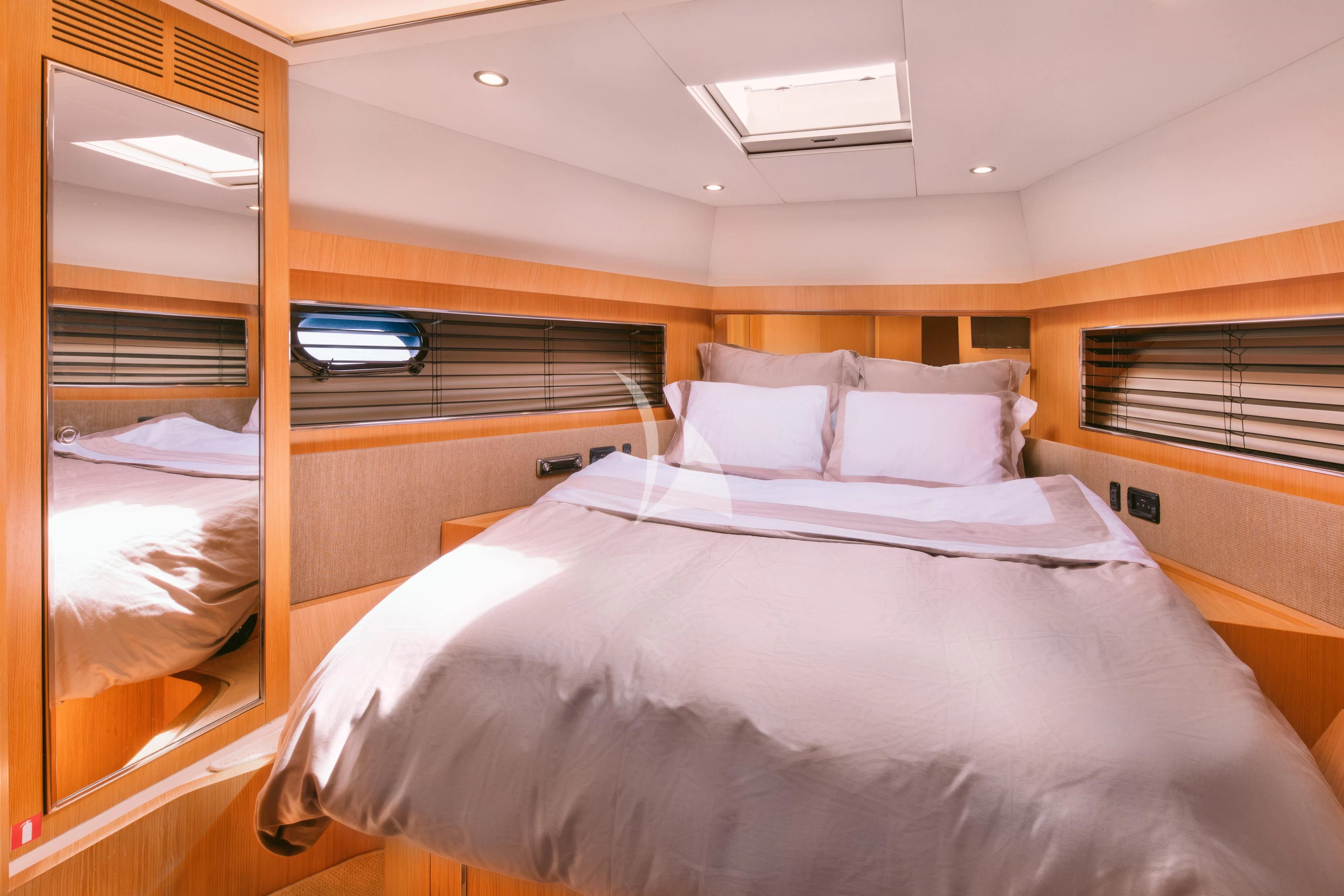 a room with a bed and a window aboard WHO CARES Yacht for Sale