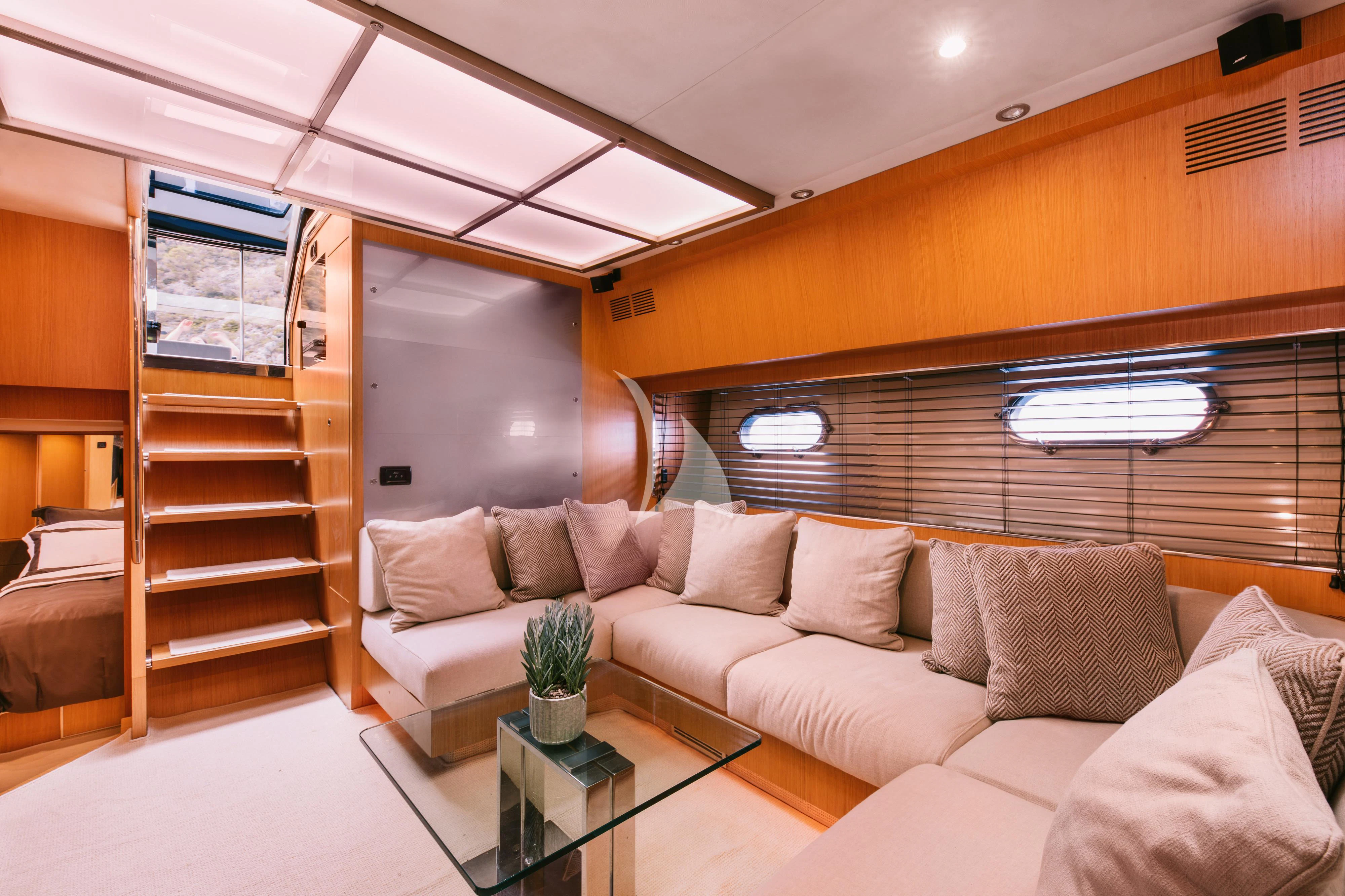 a living room with a couch and a coffee table aboard WHO CARES Yacht for Sale