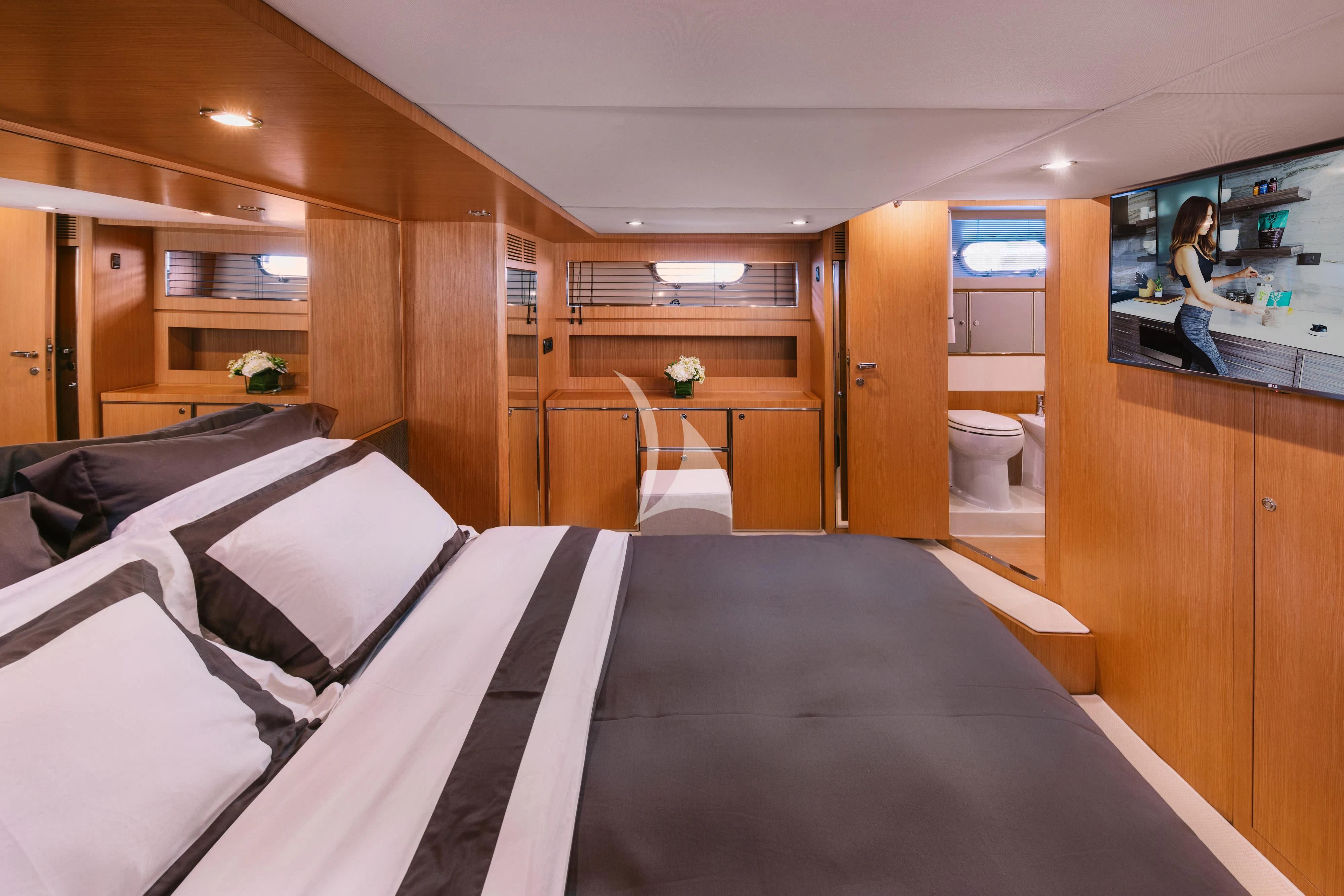 a room with a bed and a mirror aboard WHO CARES Yacht for Sale