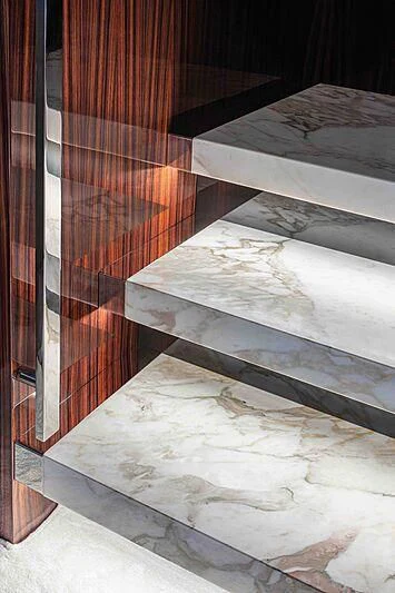 a staircase with a glass window aboard GREY SHARK Yacht for Sale