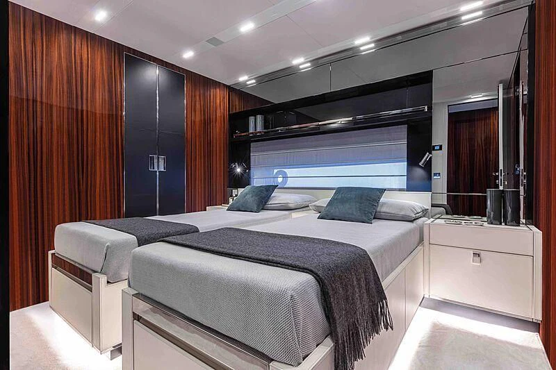 a room with a bed and a desk aboard GREY SHARK Yacht for Sale