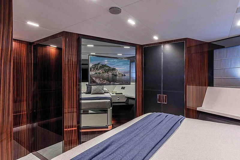 a room with a bed and a large mirror aboard GREY SHARK Yacht for Sale