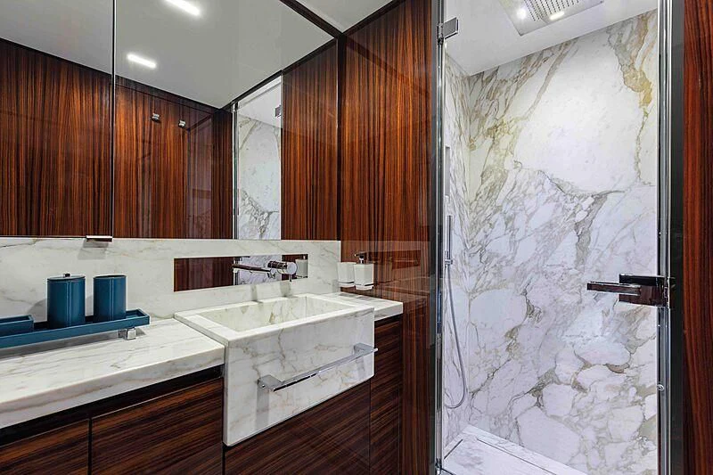 a bathroom with wooden cabinets aboard GREY SHARK Yacht for Sale