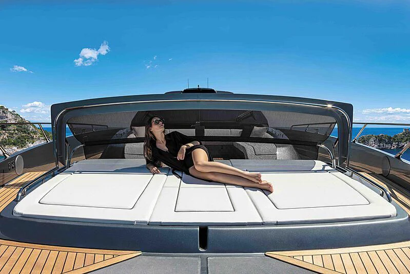 a person sitting in a convertible car aboard GREY SHARK Yacht for Sale