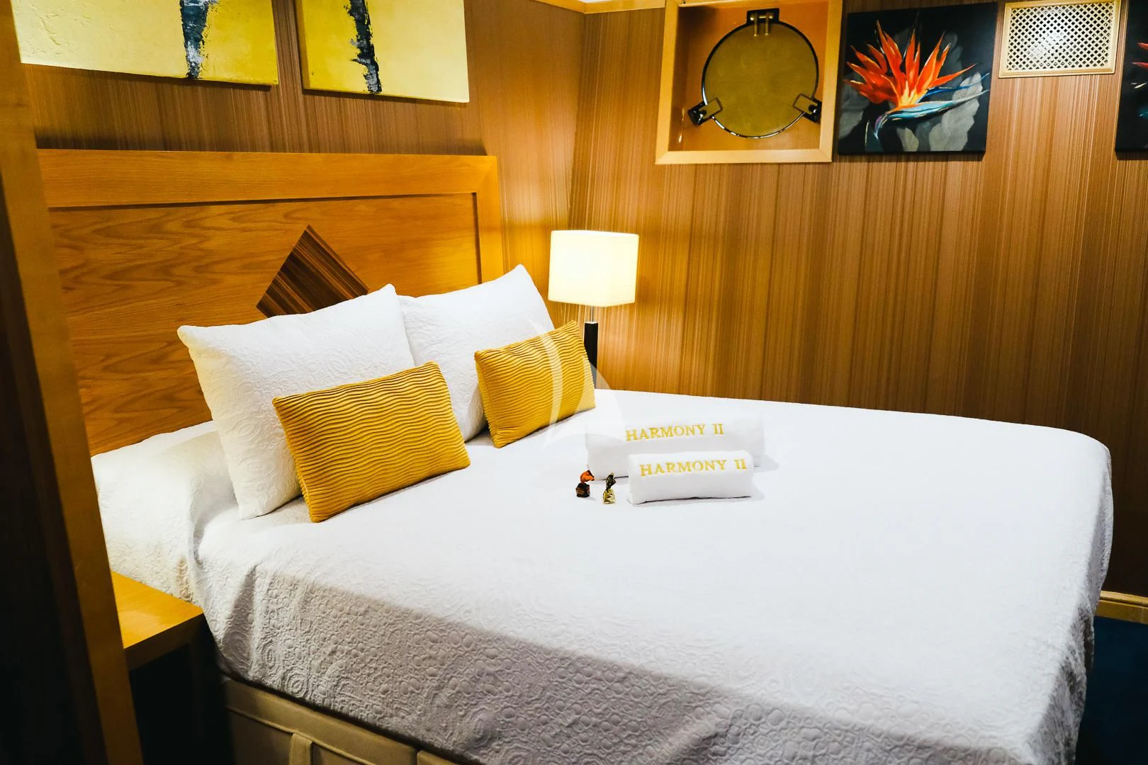 a bed with pillows and a lamp aboard HARMONY II Yacht for Sale