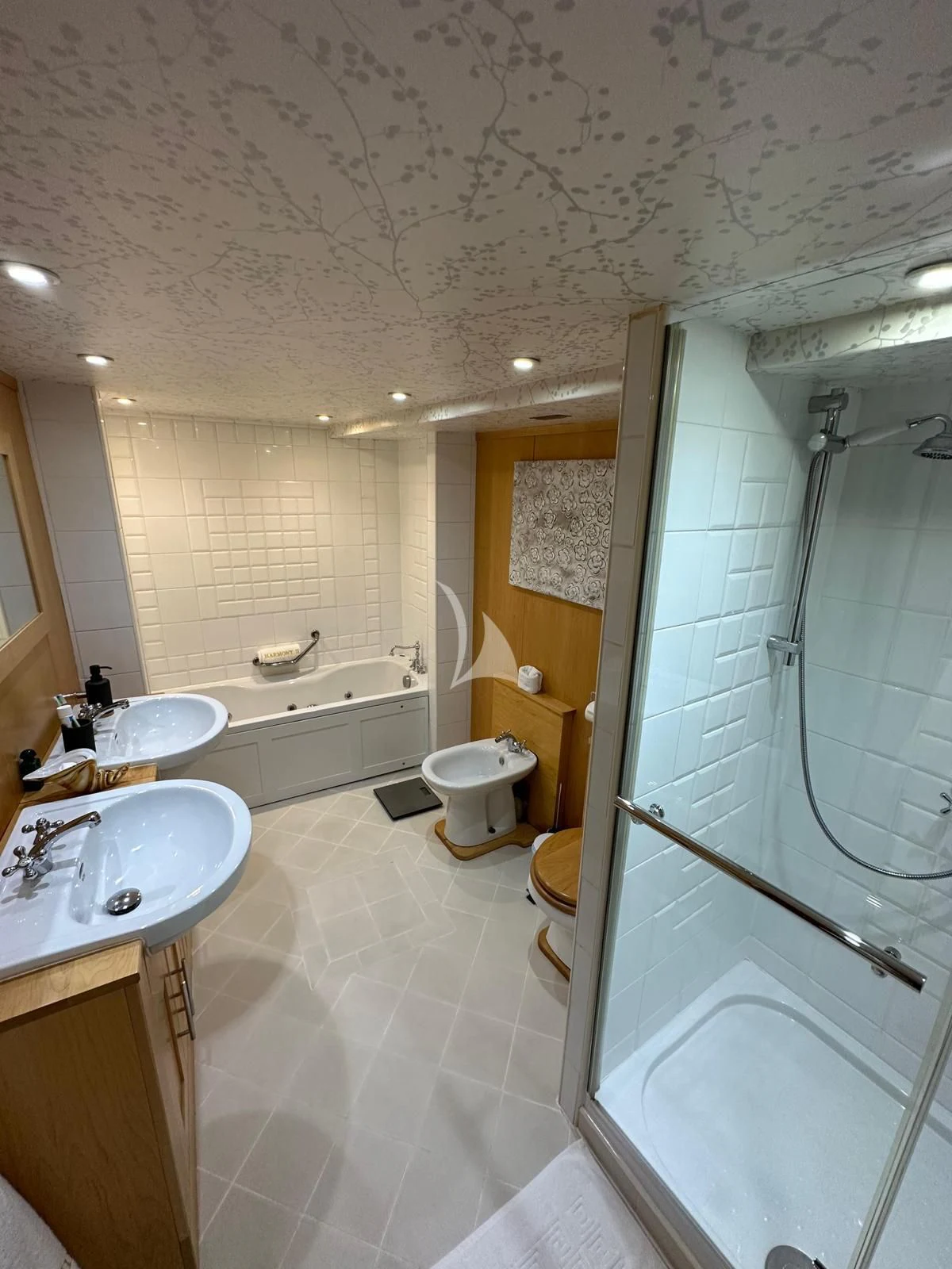 a bathroom with a glass shower aboard HARMONY II Yacht for Sale