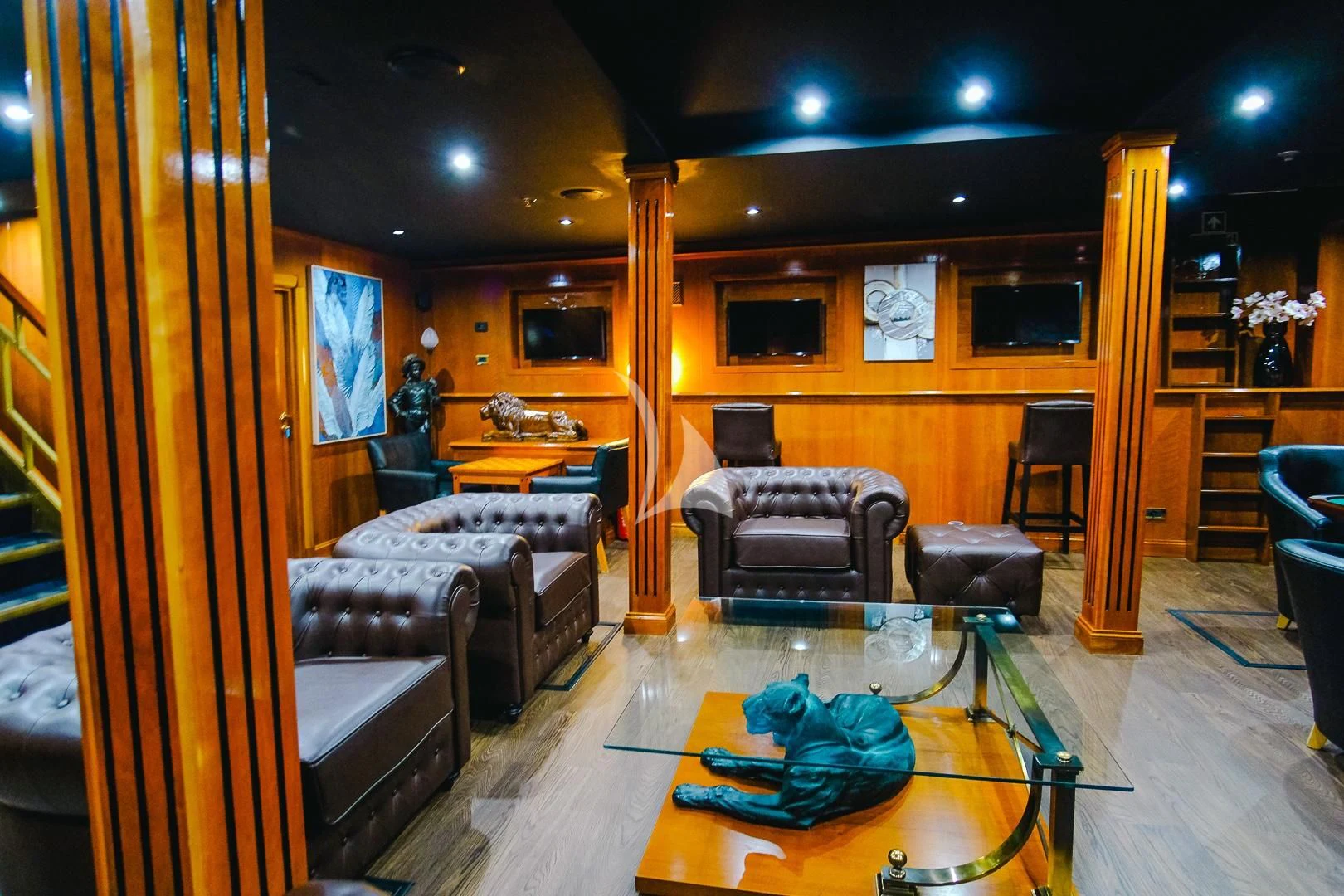 a living room with a couch and a coffee table aboard HARMONY II Yacht for Sale