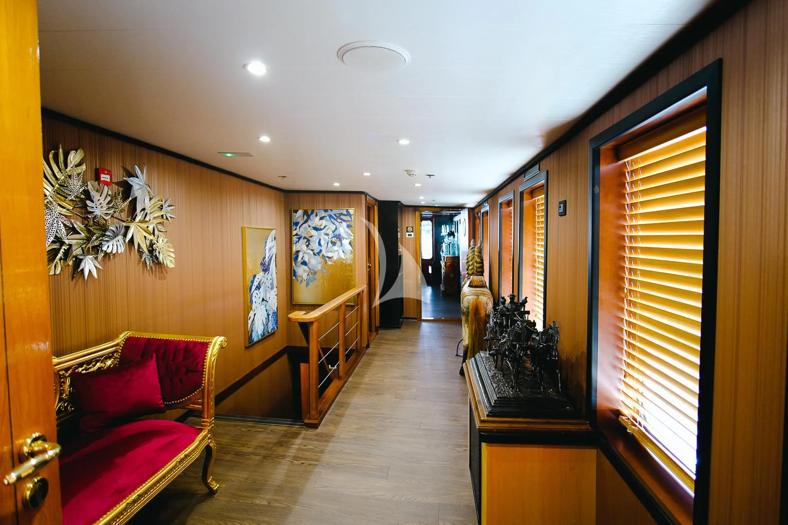 a room with a bed and a chair aboard HARMONY II Yacht for Sale