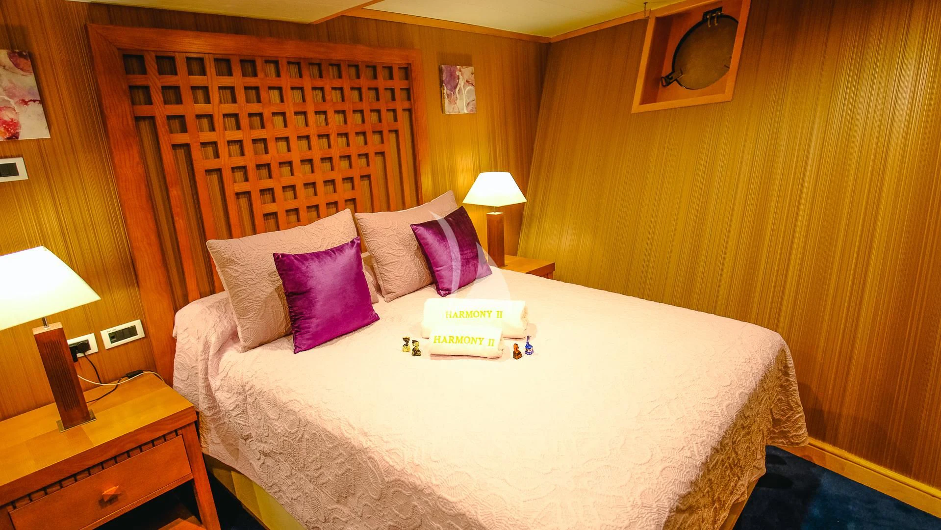 a bed with a white sheet and pillows aboard HARMONY II Yacht for Sale