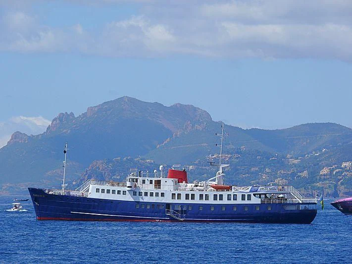 a large blue and white boat in the water aboard HARMONY II Yacht for Sale