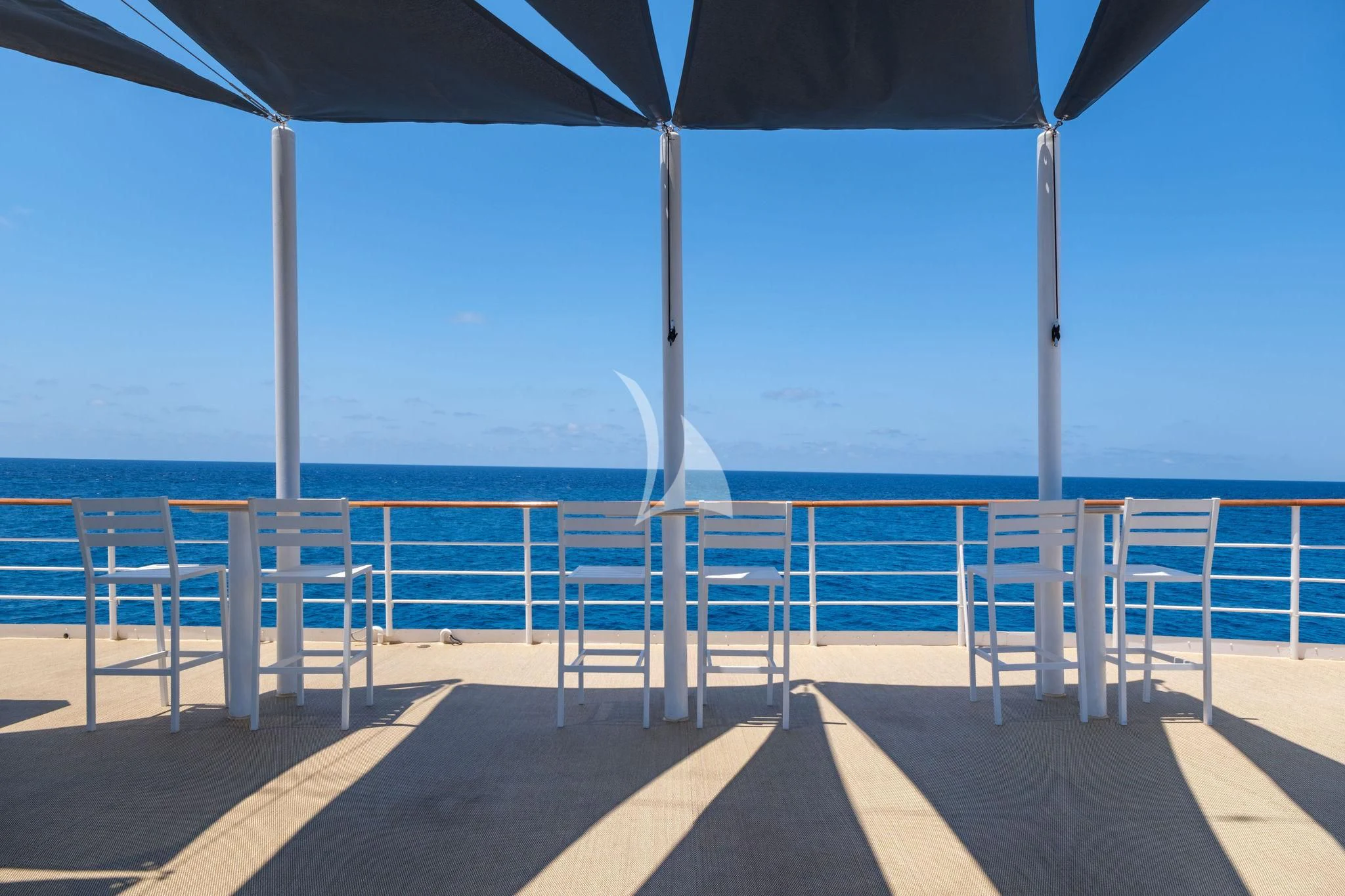 a deck with chairs and a railing aboard HARMONY II Yacht for Sale