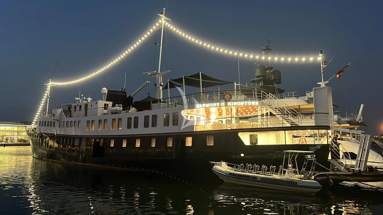 a large ship with lights on the top aboard HARMONY II Yacht for Sale