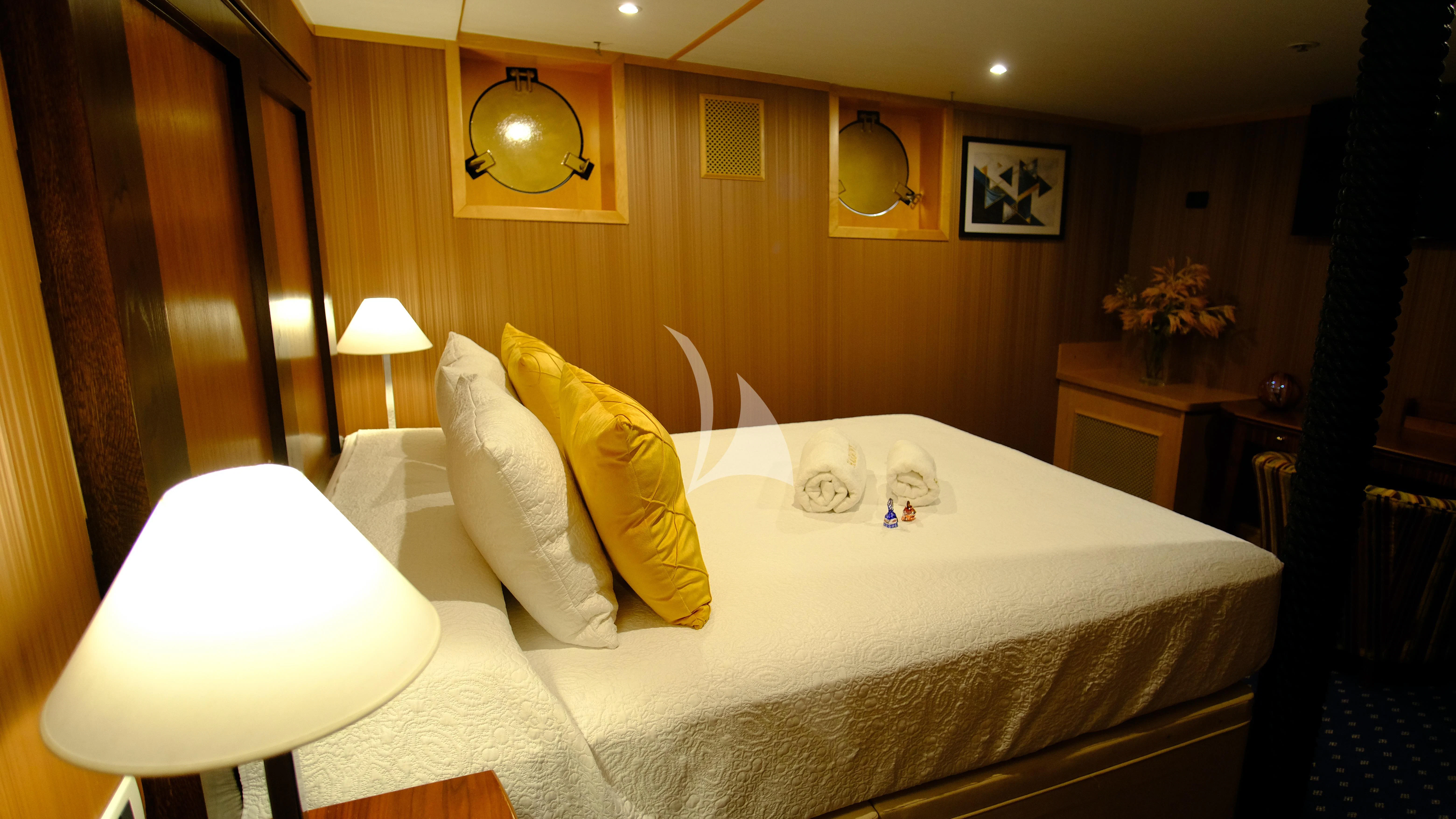 a bed with white sheets aboard HARMONY II Yacht for Sale