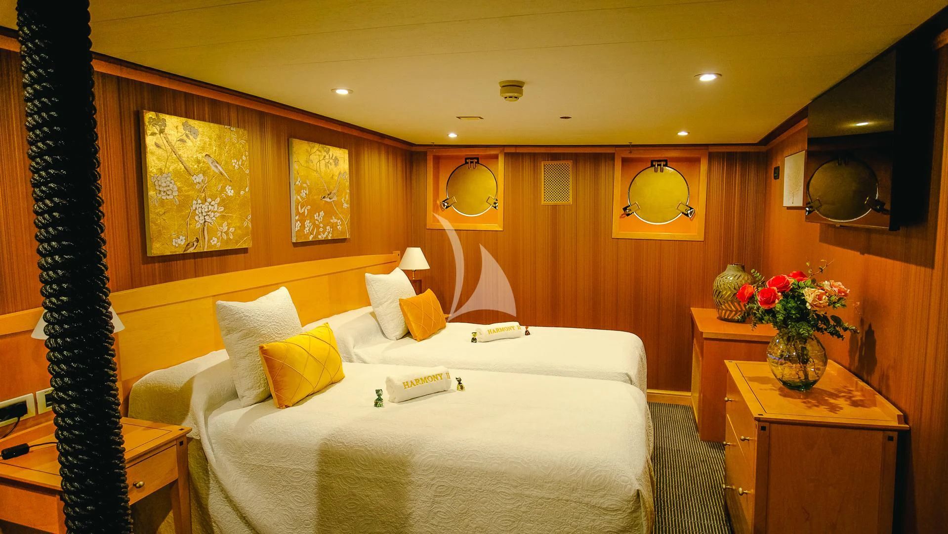 a bedroom with a bed and a desk aboard HARMONY II Yacht for Sale