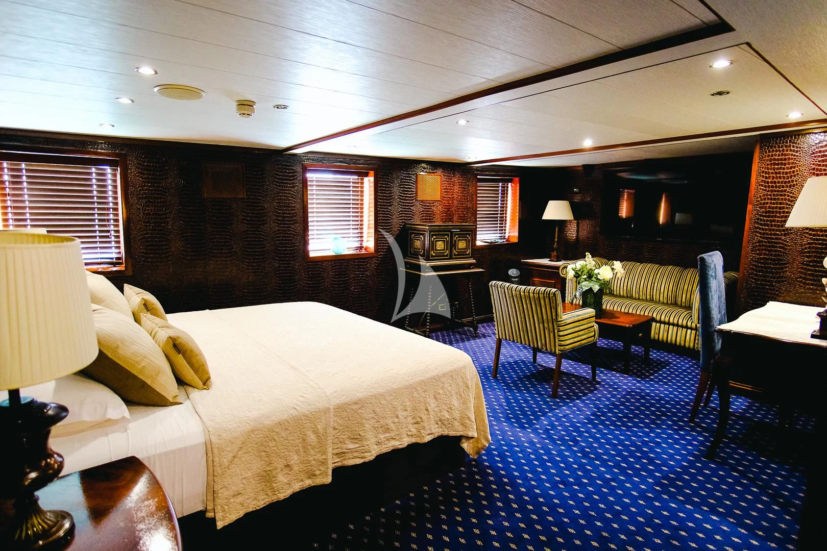 a hotel room with a bed and chairs aboard HARMONY II Yacht for Sale