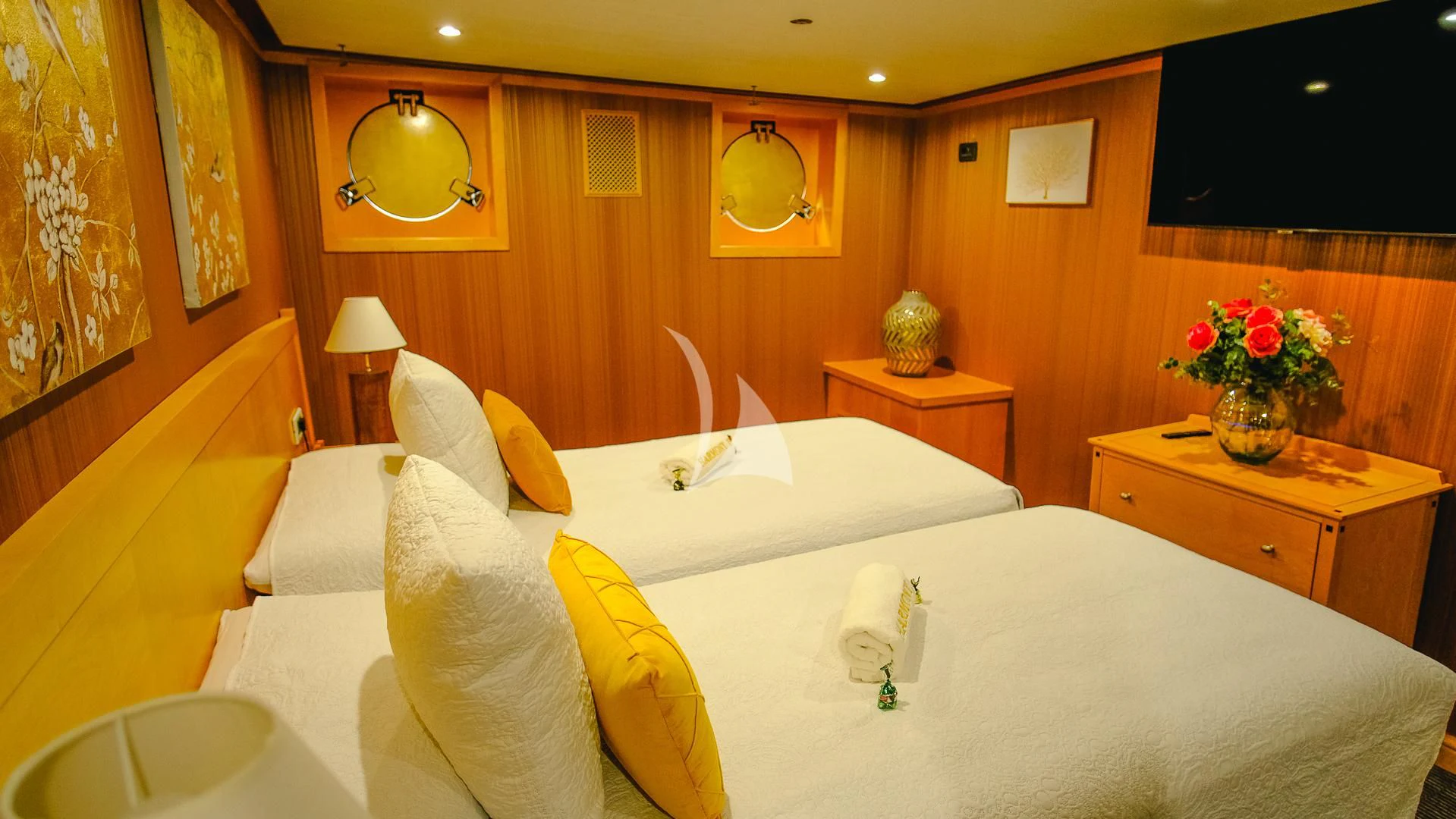 a room with a bed and a table aboard HARMONY II Yacht for Sale