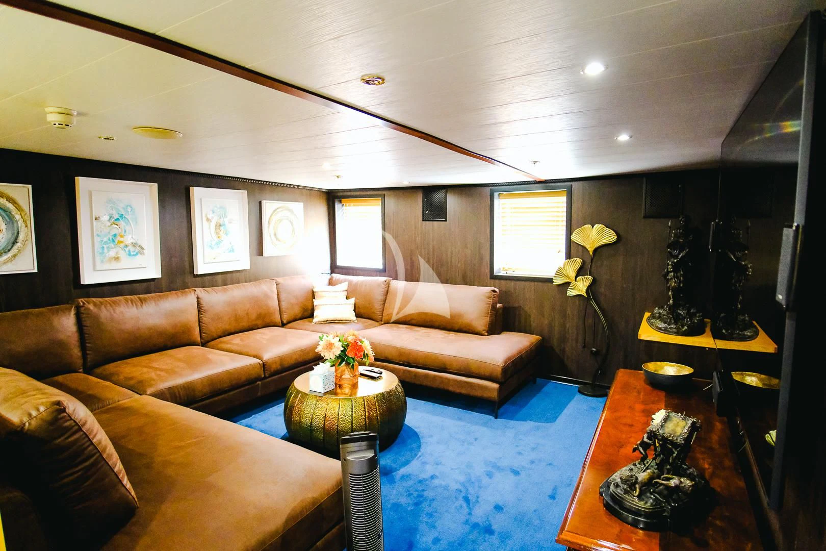 a living room with a couch and a coffee table aboard HARMONY II Yacht for Sale