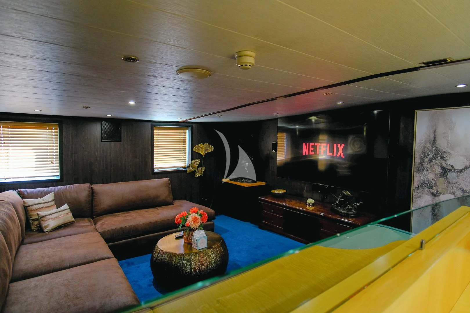 a living room with a couch and a television aboard HARMONY II Yacht for Sale