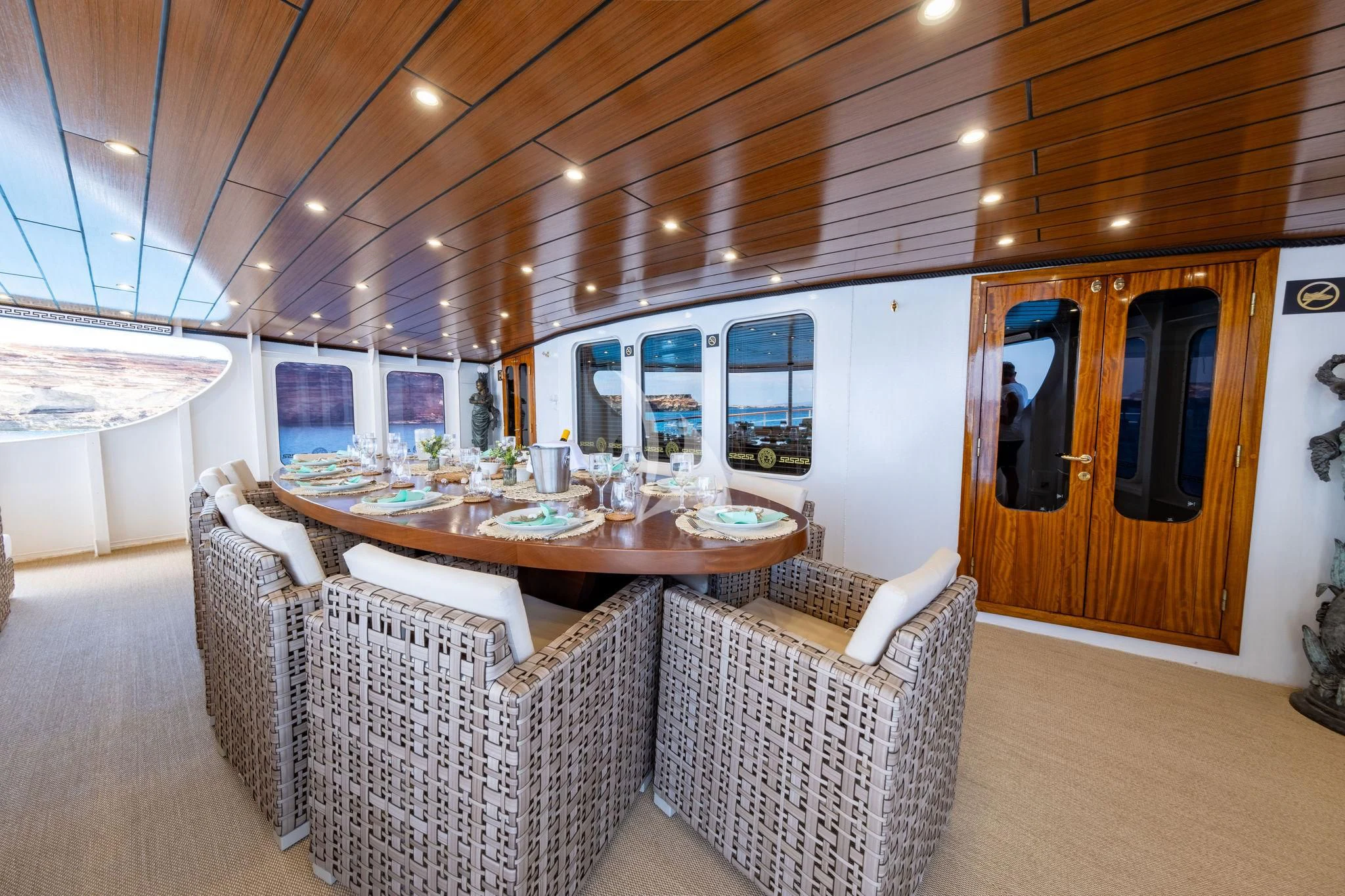 a living room with a table and chairs aboard HARMONY II Yacht for Sale