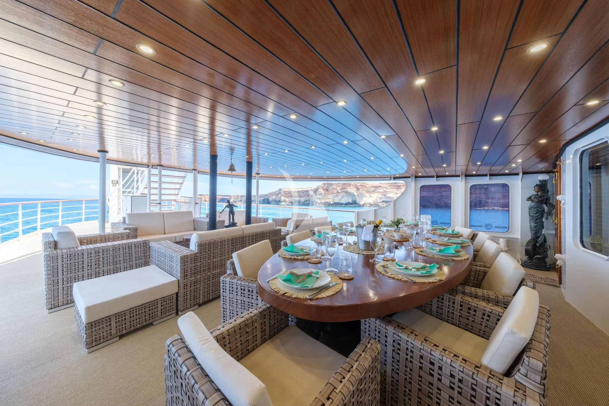 a living room with a large table and chairs aboard HARMONY II Yacht for Sale